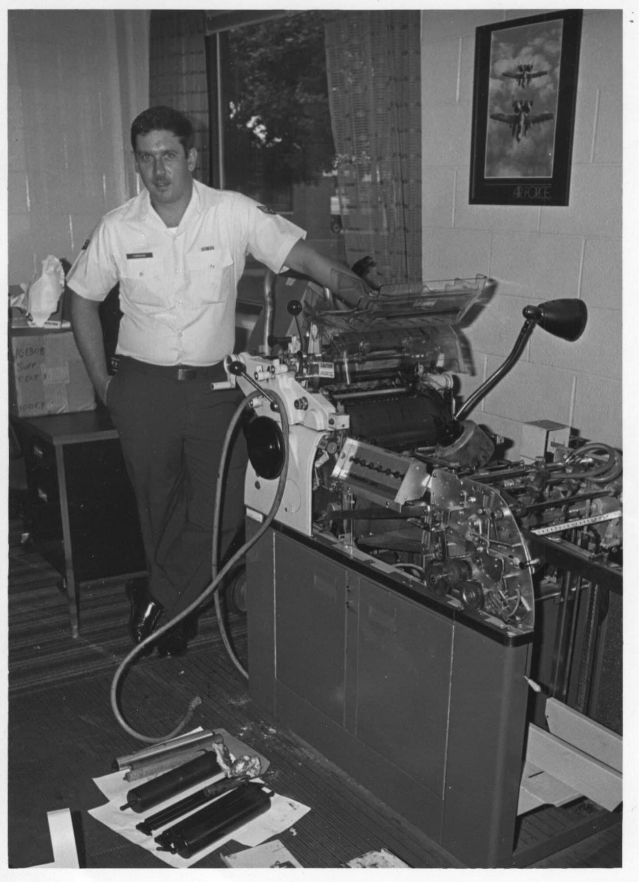 BradX in Air National Guard uniform beside a press